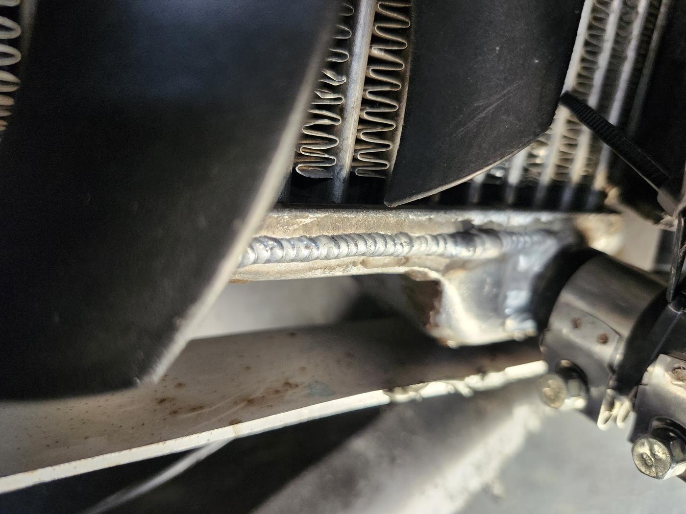 Close up of a finished weld bead running along a frame member