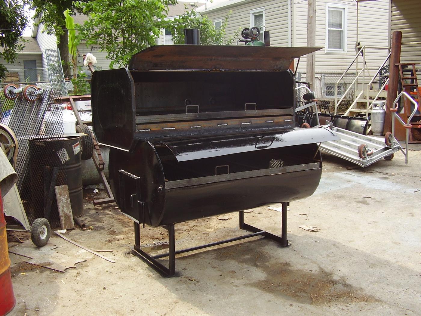 A custom barbecue smoker with a barrel body, hinged lid and a welded steel stand